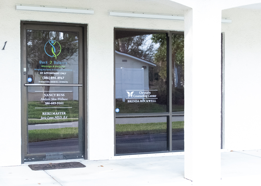 Door with window decals for Back 2 Balance Wellness Center and Chrysalis Counselors.